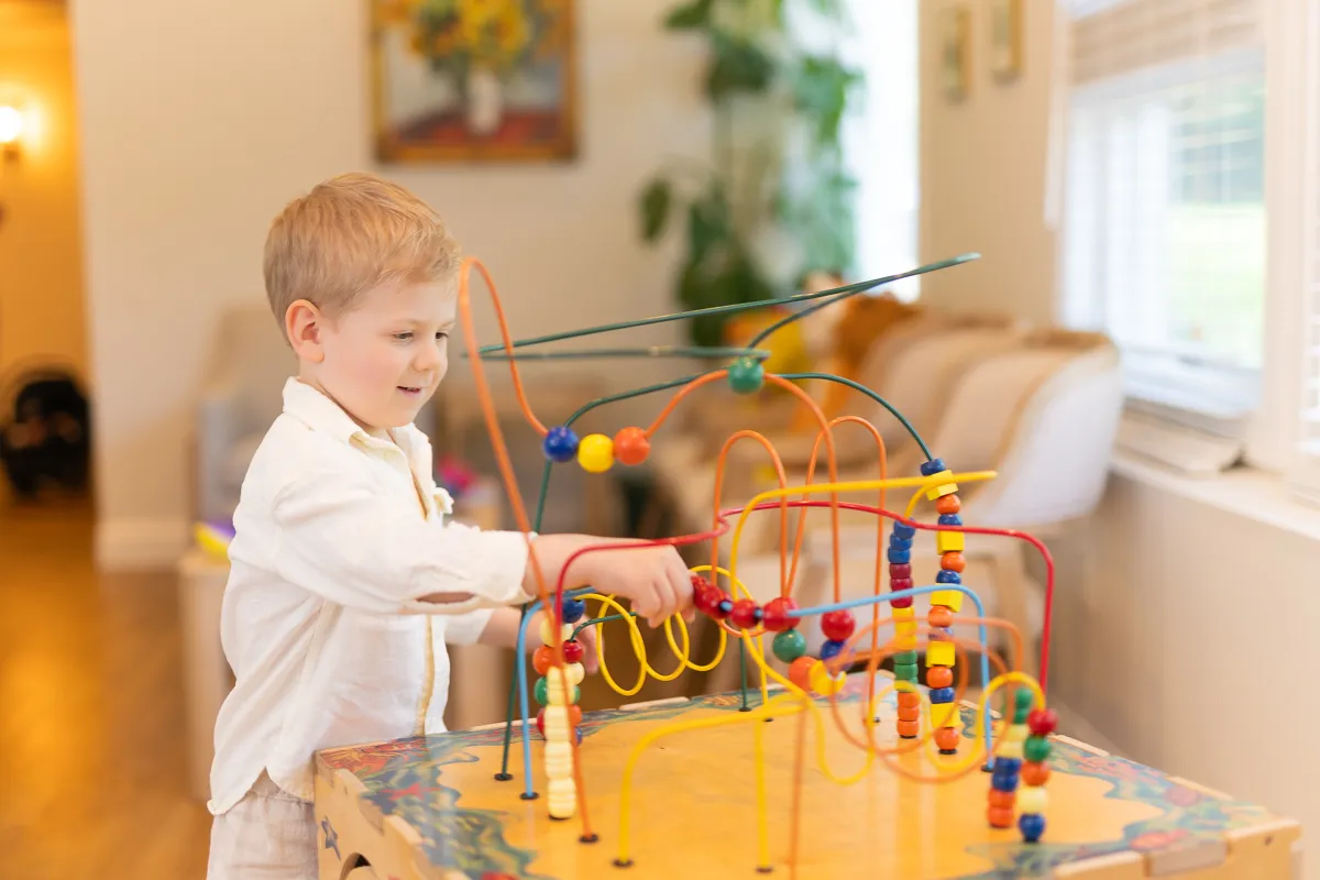 A child playing with the bead-maze toy in the waiting area