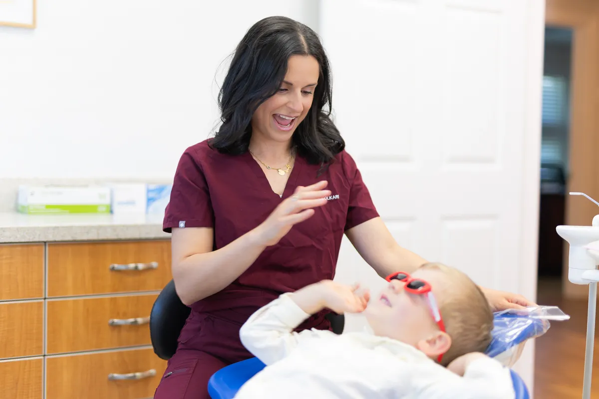 A dentist caring for a patient in the dental chair