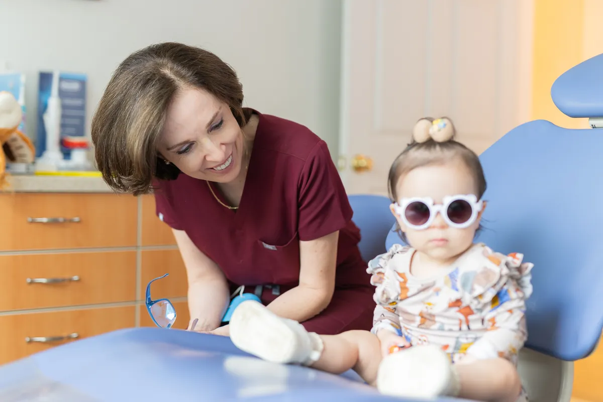 A dentist with an infant patient at Darien Pediatric Dentistry