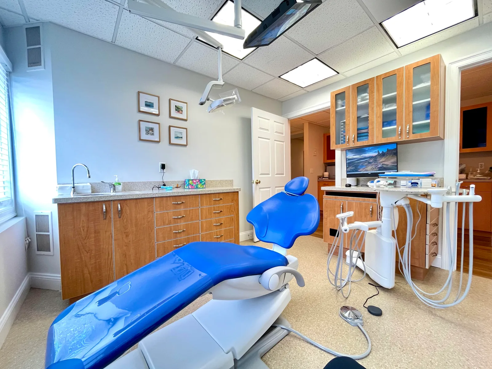Treatment room with a blue dental chair