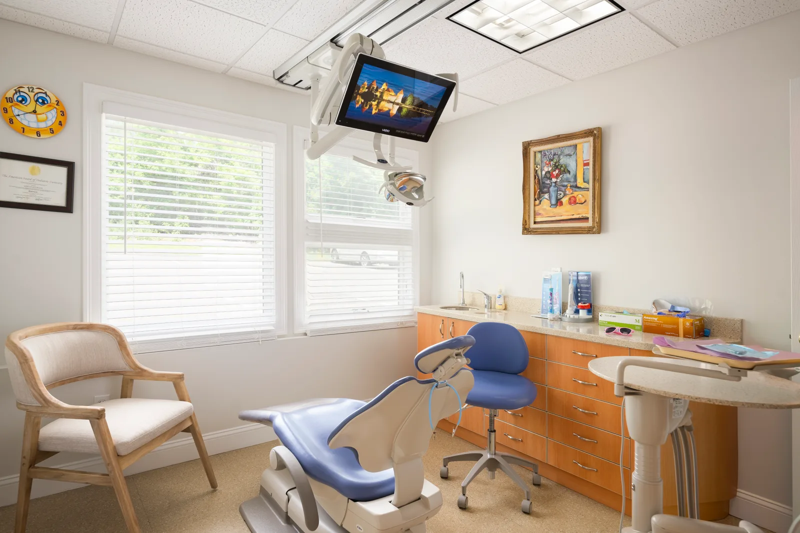 Treatment room with a blue dental chair