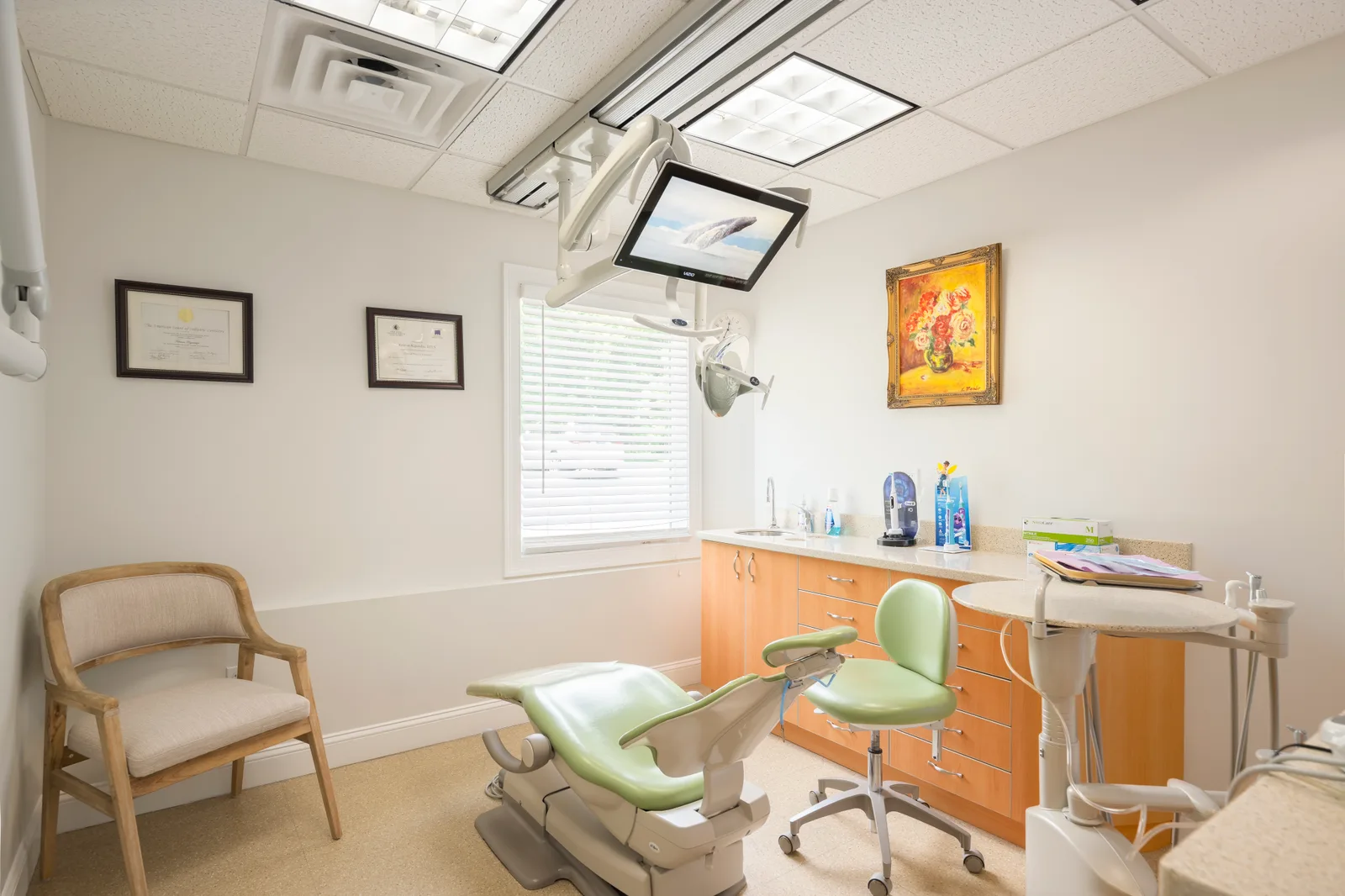 Treatment room with a green dental chair