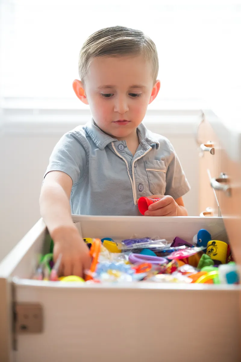 A child exploring the toy chest in the Darien Pediatric Dentistry waiting room