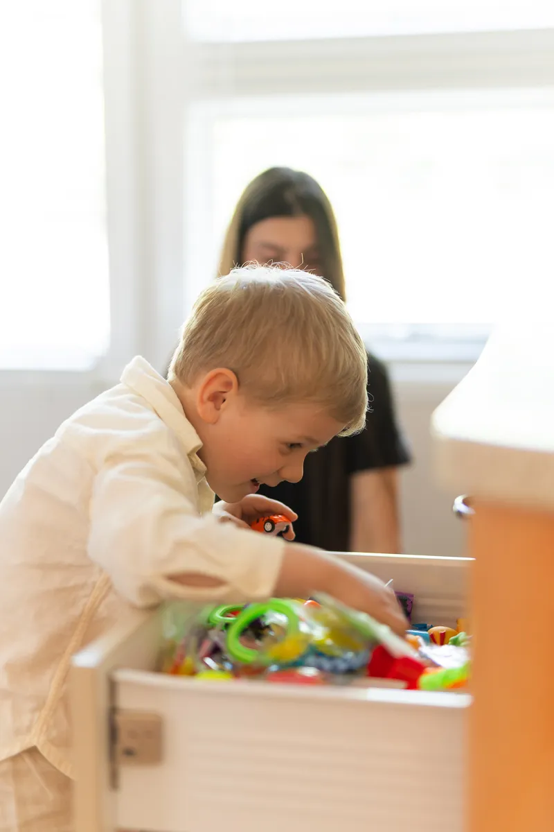 A child exploring the toy drawer in the waiting room